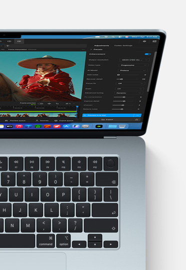 A Macbook Air screen showing a video getting enhanced with AI in Topaz Video.