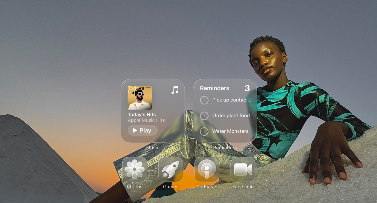 Liquid Glass display with clear app icons, like Apple Music, Reminders, Photos, Games, Podcasts and FaceTime refracting against the wallpaper