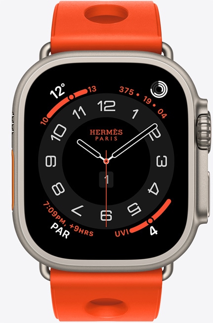 ساعة Apple Watch Hermès Ultra 3، واجهة الساعة بعقارب Circulaire، (عقارب الساعة والدقيقة والثانية، الإضافات: الطقس، حلقات النشاط، الوقت في باريس، مؤشر الأشعة فوق البنفسجية)، إطار تيتانيوم، لون طبيعي، الجانب الخارجي الأيمن، التاج الرقمي، زر جانبي بارز، مع حزام Scub'H Diving، لون برتقالي نيون (برتقالي ساطع)، مطاط مقولب، فتحات دائرية في الوسط