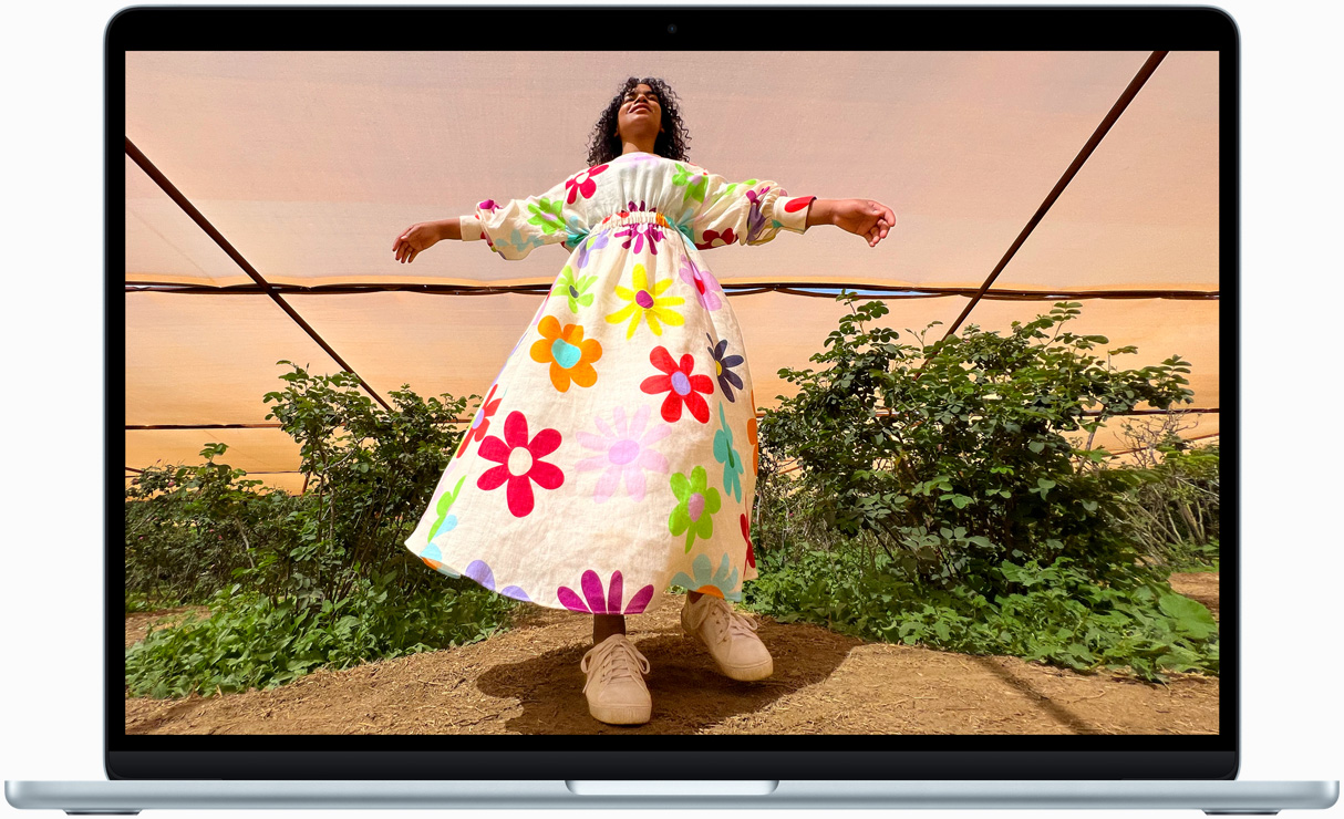 MacBook Air screen showing photo of person in colorful outfit, demonstrating color range and resolution of Liquid Retina display