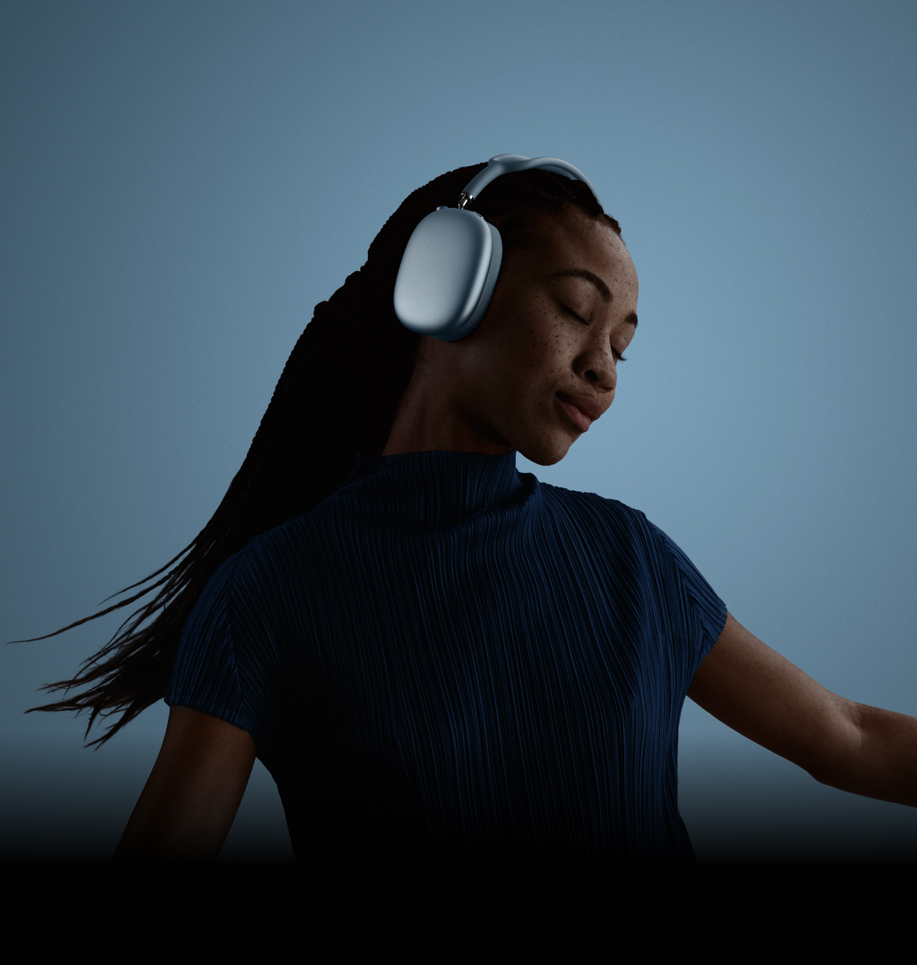 Μια γυναίκα με κλειστά τα μάτια της και το κεφάλι της γερμένο προς τα αριστερά, η οποία φορά τα AirPods Max.