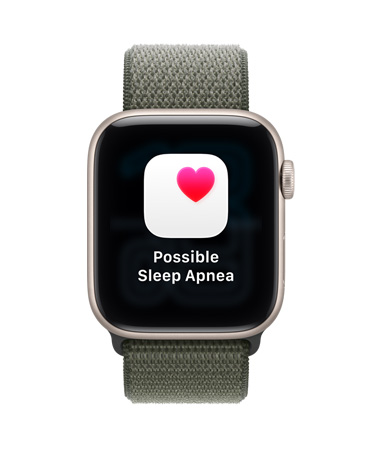 Apple Watch SE 3, carcasă din aluminiu, culoare Strălucire stelară, notificare de posibilă apnee de somn, inimă roz într-o casetă albă, partea exterioară dreaptă, Digital Crown, brățară Sport, culoare Pădure