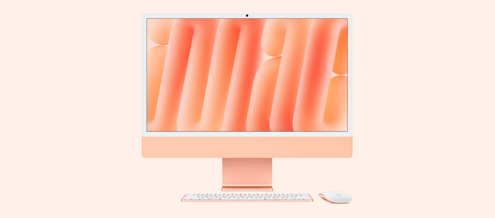 同じカラーのマウスとキーボードを合わせたオレンジのiMacを正面から見た図