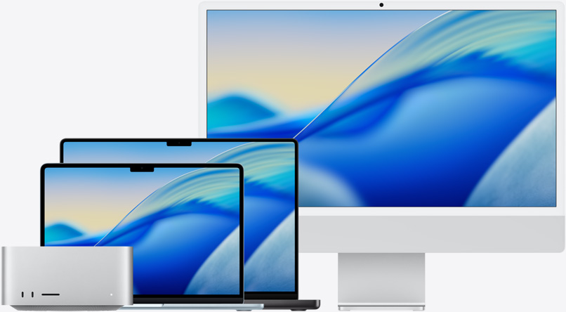 Tapeta macOS Tahoe na celé rodině modelů Macu zleva doprava: Mac Studio, 13palcový MacBook Air v blankytně modré, 14palcový MacBook Pro ve vesmírně černé a 24palcový iMac ve stříbrné